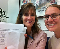 Photo: Teacher Action Network members Megan Markevich & Marisa Crabtree hold up petitions for online voting in UTLA