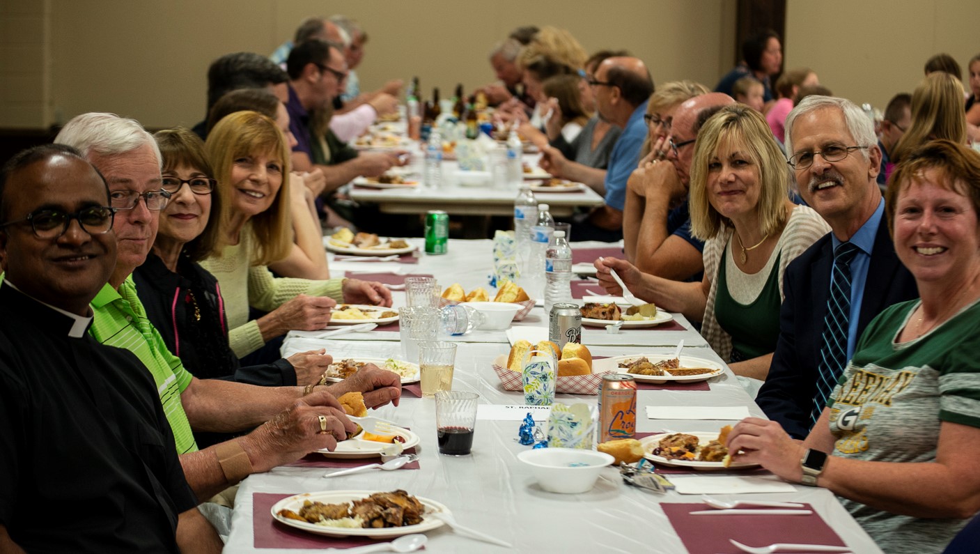 Oshkosh w Fr. Louis at_table_with_Fr._Louis.jpg