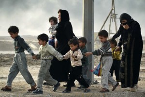 Iraqi women and children fleeing bombs