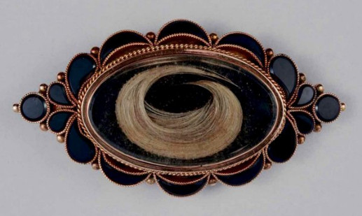 image of black jewelty with locket of hair inside