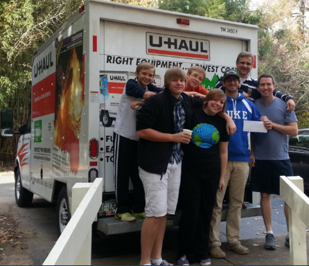 members ready to move (in front of a U-Haul truck)