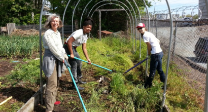 Congregation members working in garden at service project at SEEDS