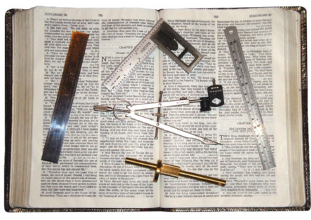 photo of rulers, dividers, and other measuring instruments on top of an open Bible