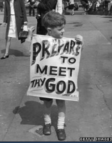 photo of child holding a sign 'PREPARE TO MEET THY GOD'