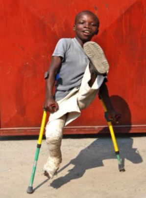 photo of boy kicking one foot high