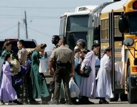 women and children being loaded onto bus
