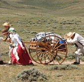 two people pulling and pushing a handcart