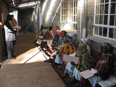 photo of chaplain reading with/to patients waiting outdoors