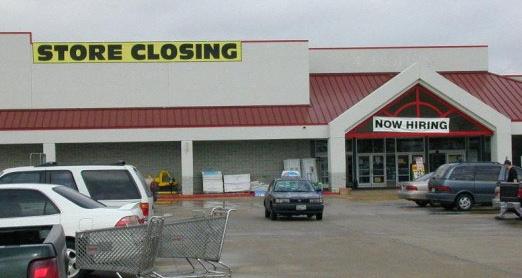 photo with 'STORE CLOSING' and 'NOW HIRING' banners both hung outside same store