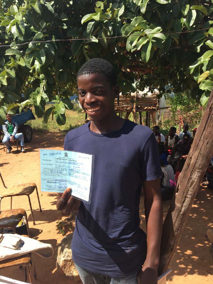 photo of a teenager holding his birth certificate