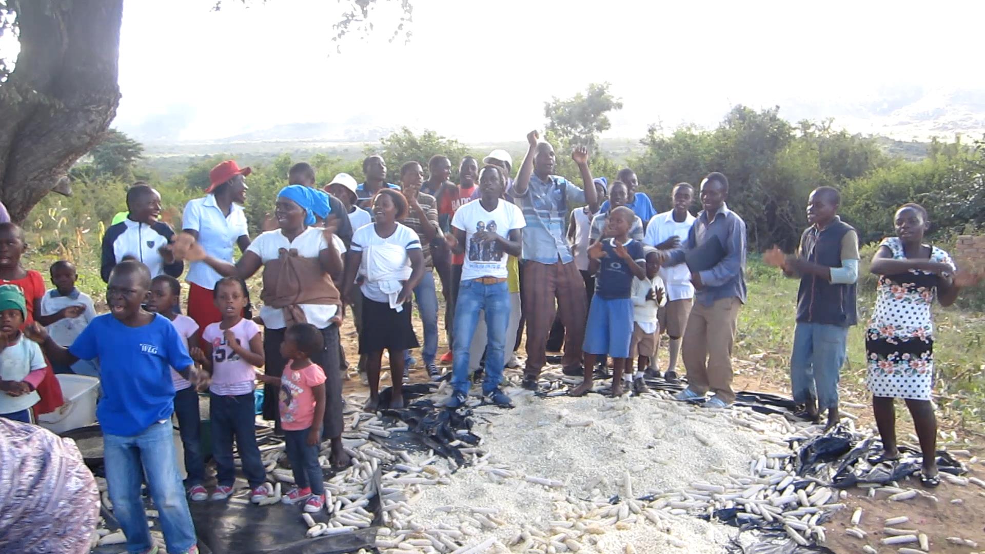 photo of group around a pile of cornmeal