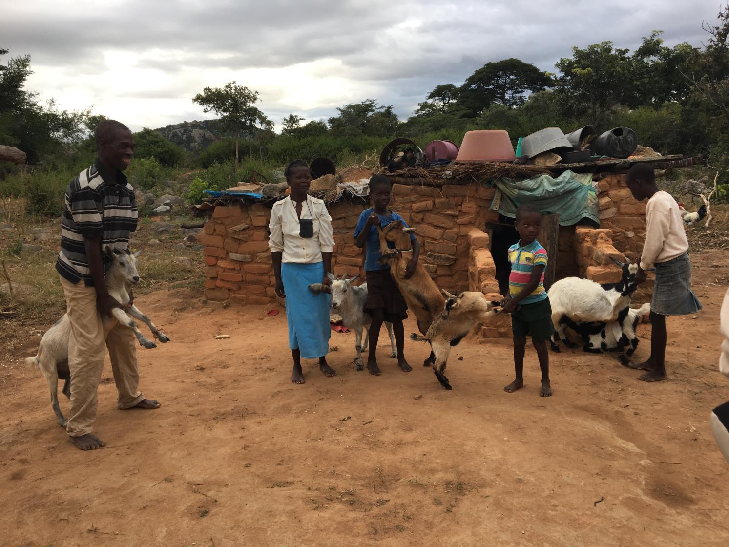 photo of teenagers with four goats