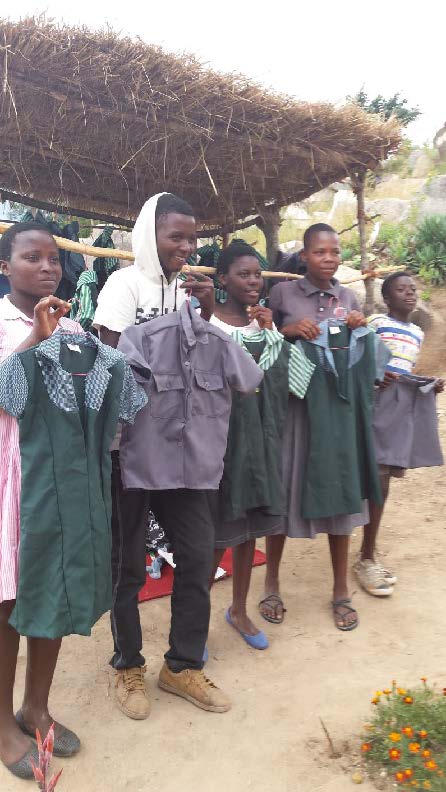 photo of teenagers holding new uniforms