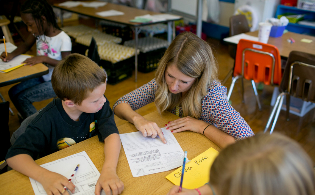 Allison Pitt, a third-grade teacher in Columbus, Ohio, helped Charles Swank last month at West Broad Elementary School. Photo by Andrew Spear for the New York Times.