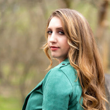 Blair Walsingham looking back toward the camera