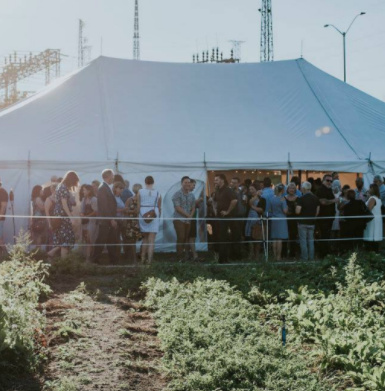 Harvest dinner attendees outside tent