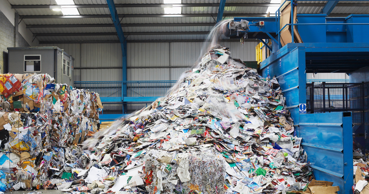 Pile of paper for recycling with more being added