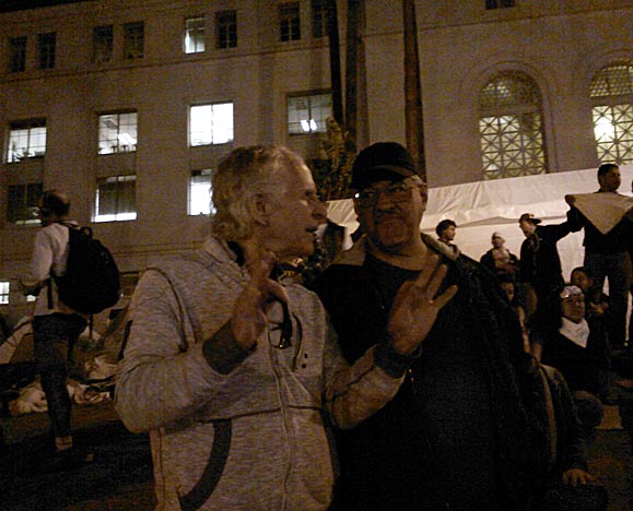 Luis Rodriguez (right) pictured at the Occupy L.A. encampment some hours before it is raided by the LAPD. Standing to Luis' right is friend, Frank Curtis.
