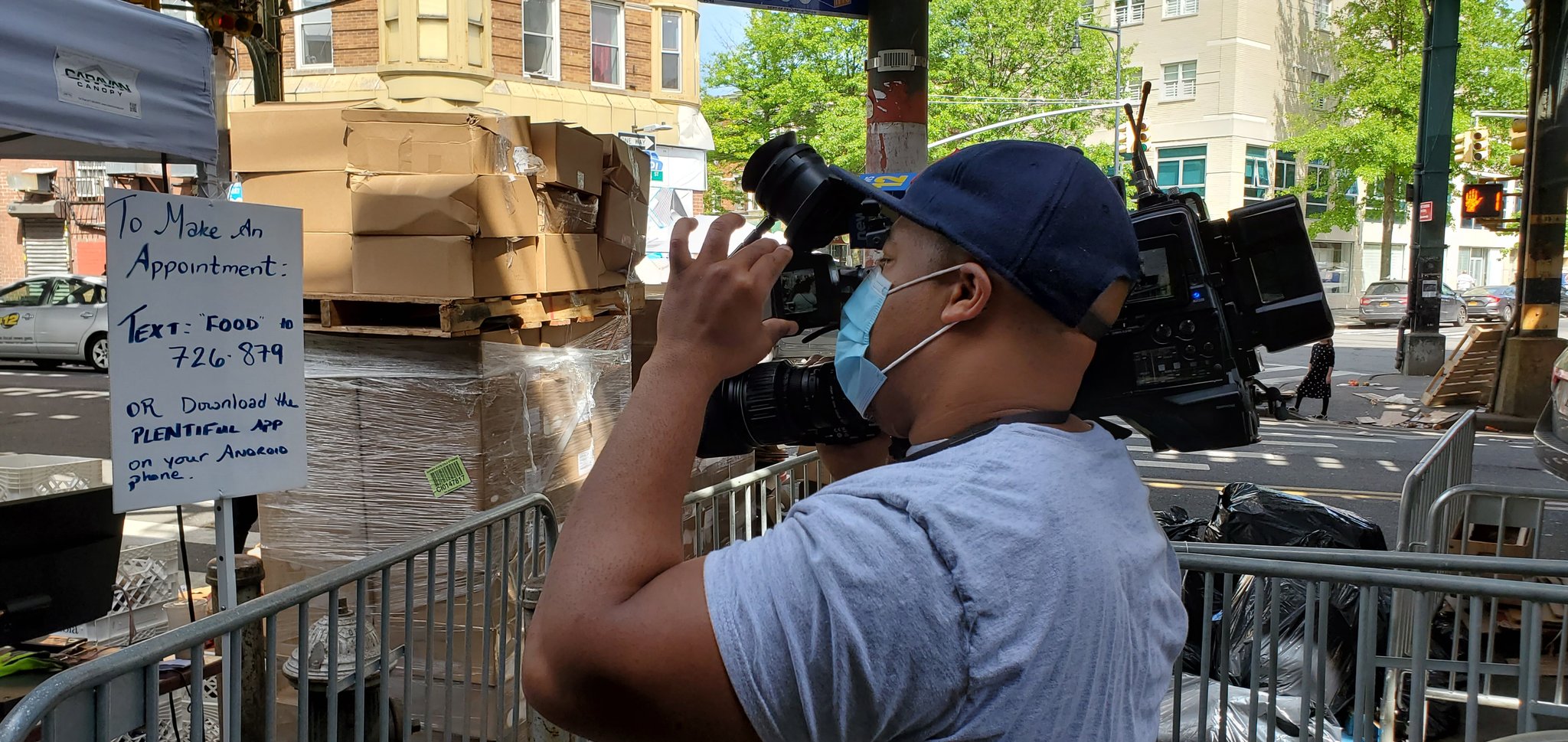 Reporter Christian L Braxton of News12 Brooklyn focusing his camera at Masbia of Boro Park during covid-19 pandemic