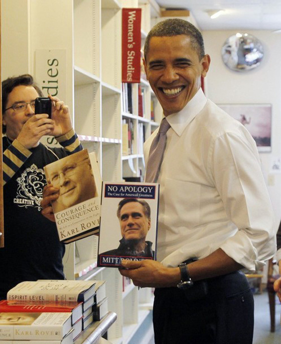 Obama smiles at Romney book