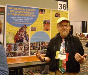 Tony Rajer posing for a picture beside his poster presentation on the Nek Chand Foundation at the AIC annual conference in Milwaukee, 2010. Image provided by Jason Church.