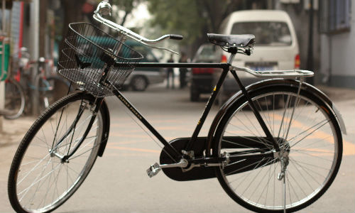 A bicycle stands in the middle of a road