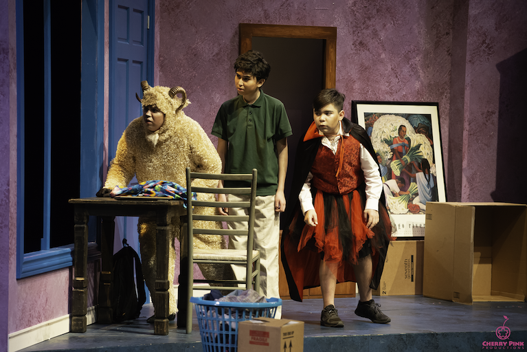 Three actors on stage in a performance of The Transition of Doodle Pequeño