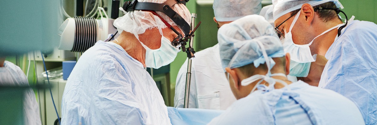 Surgeons operating in theatre.