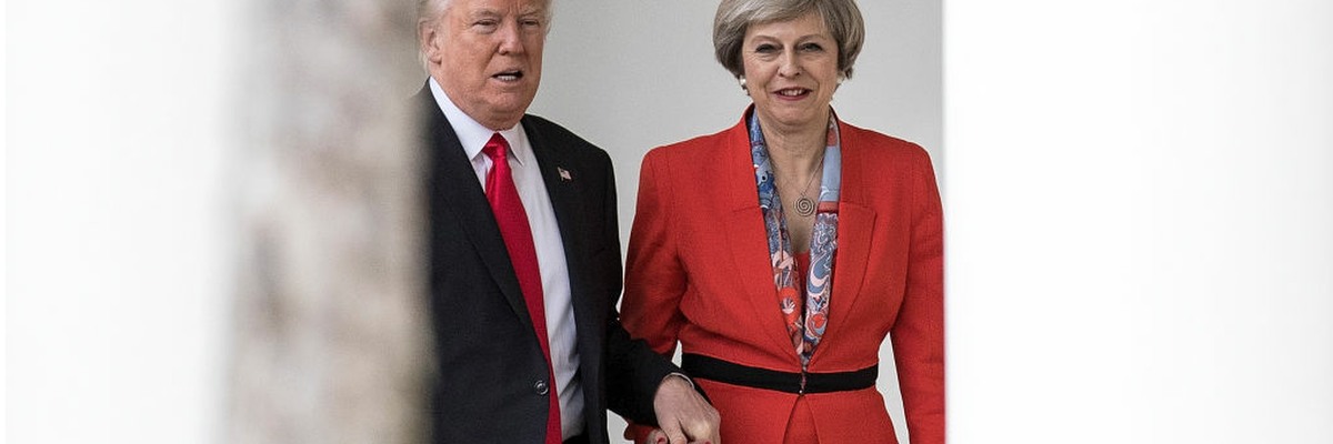 Donald Trump and Theresa May holding hands at the White House.