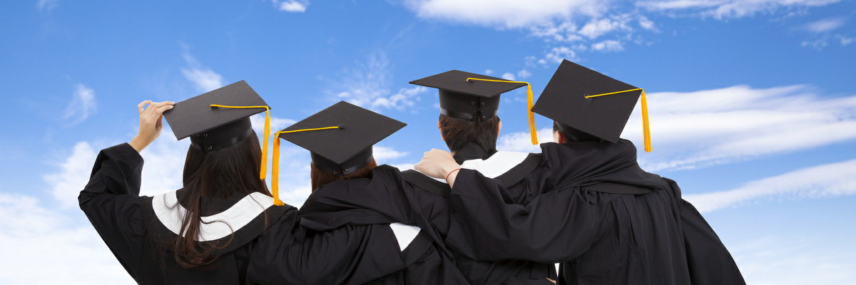 Four graduates looking away from camera.