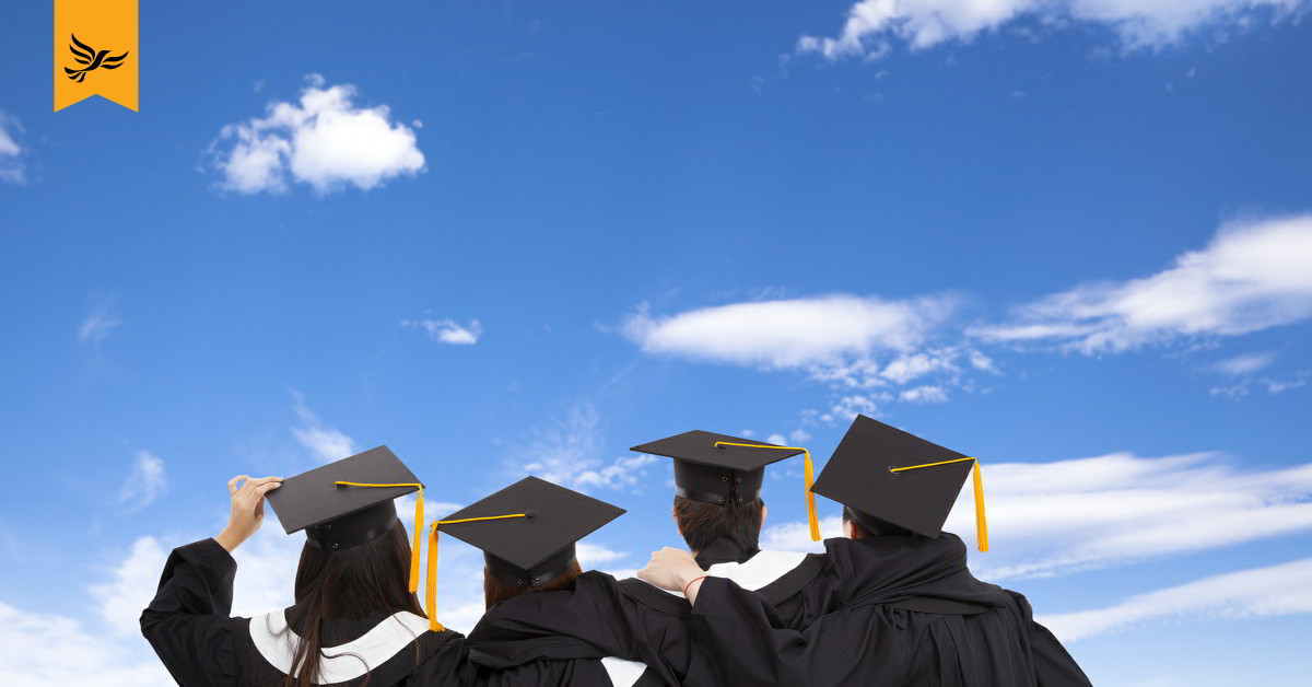 Four graduates looking away from camera.