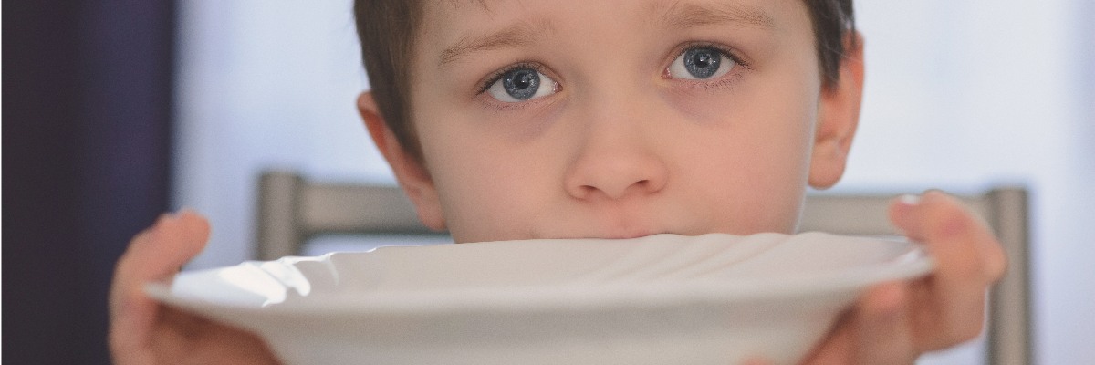 Hungry child holding bowl.