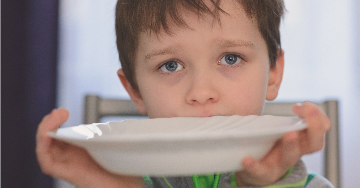 Hungry child holding bowl.