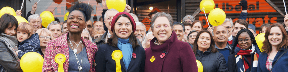 Floella Benjamin, Sarah Olney and Susan Kramer with a crowd of people