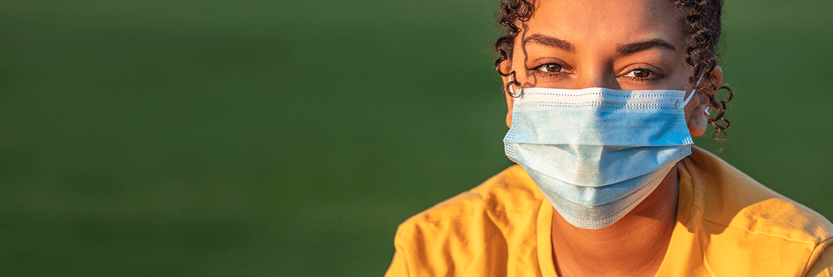 Person wearing a medical mask outdoors