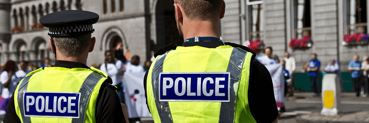 Two police officers from behind
