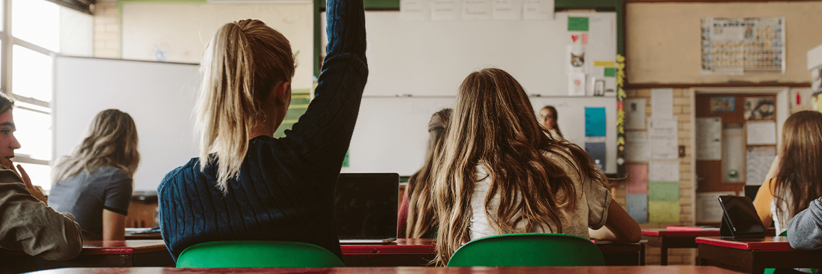 School pupils, one with their hand up
