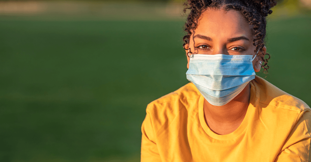 Person wearing a medical mask outdoors