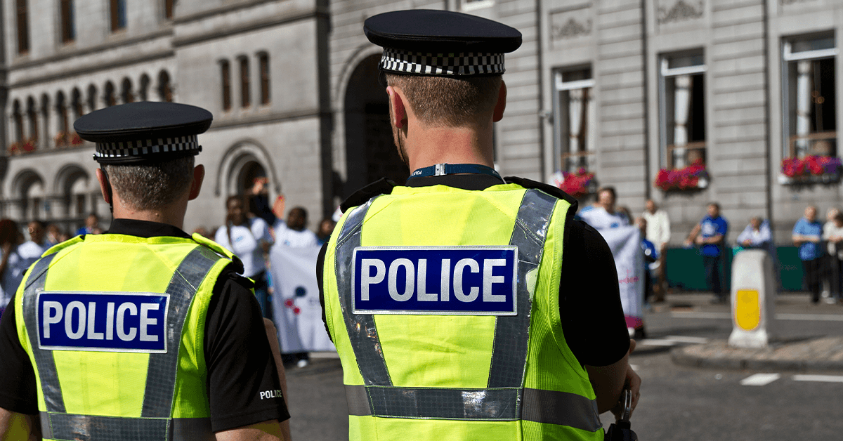 Two police officers from behind