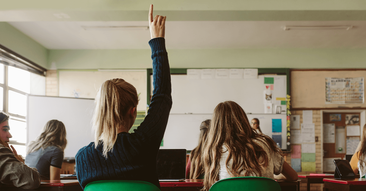 School pupils, one with their hand up