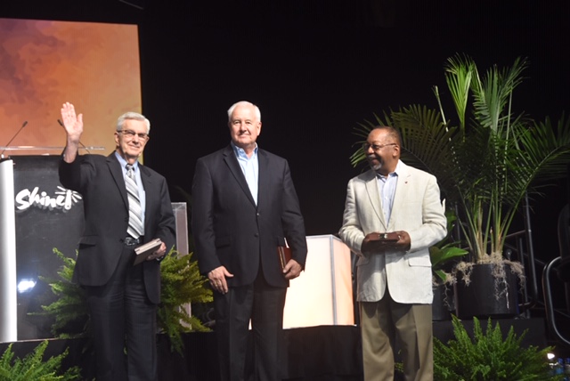At the Wisconsin Center in Milwaukee, (from left) Paul Sherry, John Thomas and Geoffrey Black are applauded by General Synod participants after receiving their medallions June 22. IMG_2540-rotated.jpg