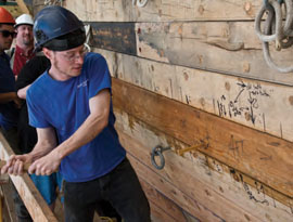 Shipwright Sean Patrick Kelly pounds in the last spike, which was specially gold-plated for the occasion. © Andy Price/Mystic Seaport Shipwright Sean Patrick Kelly pounds in the last spike, which was specially gold-plated for the occasion. © Andy Price/Mystic Seaport