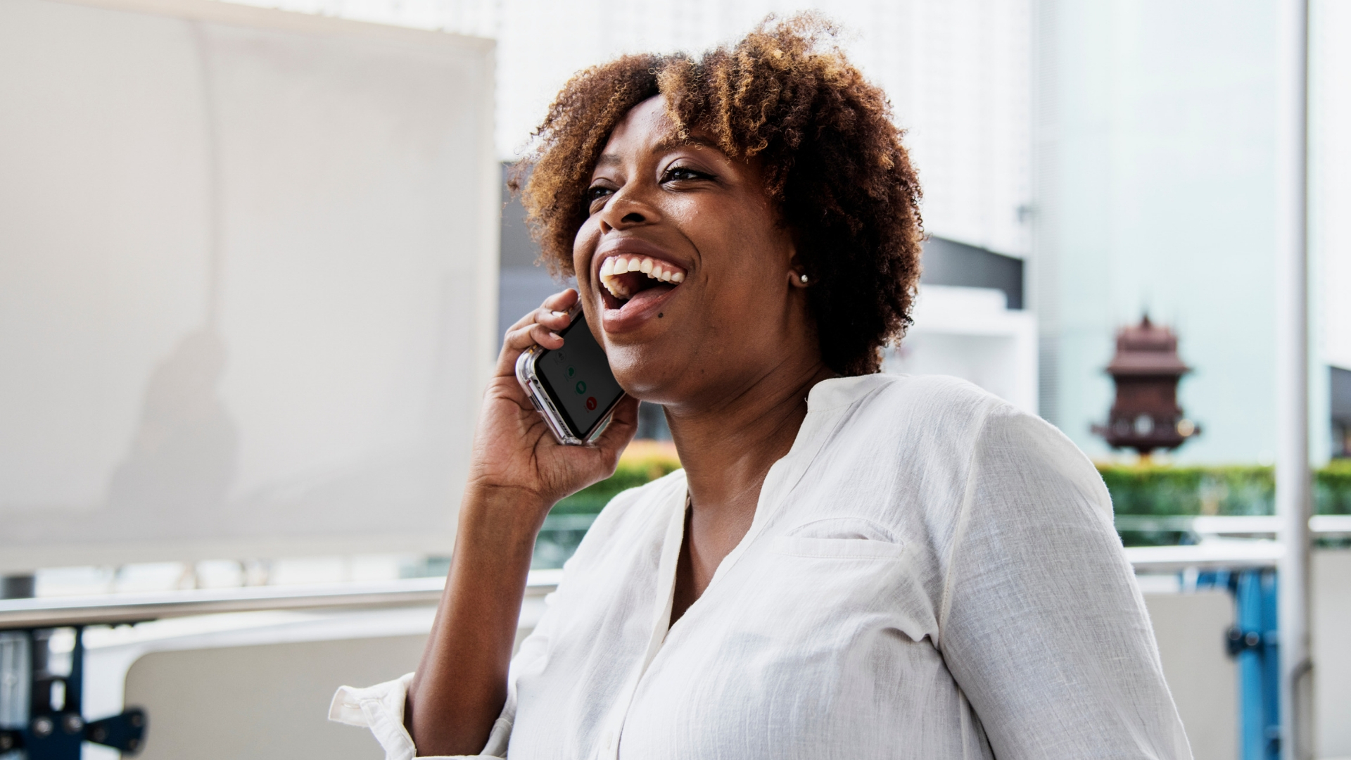 woman sitting at desk speaking on phone