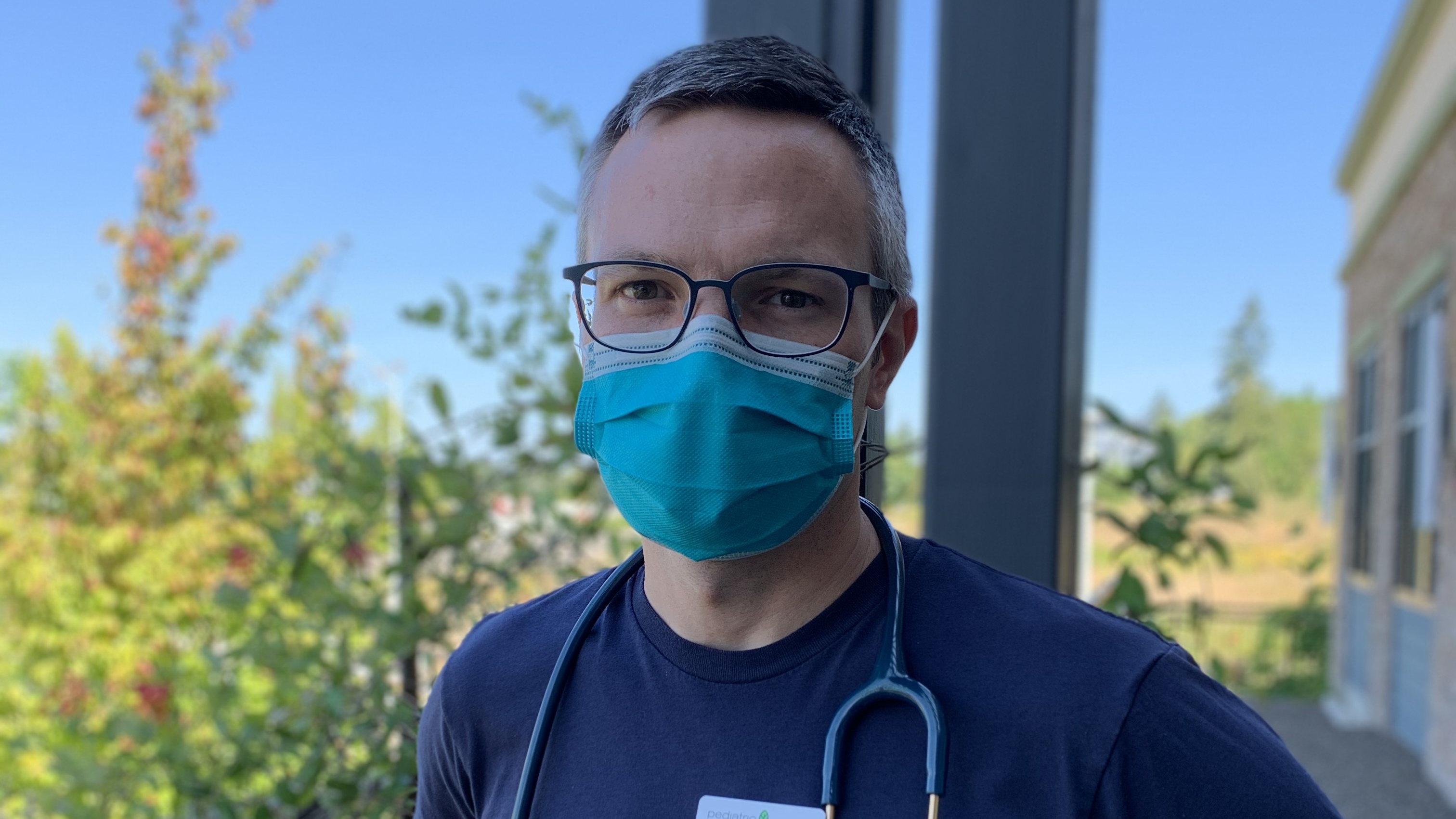 A male doctor wearing a face mask