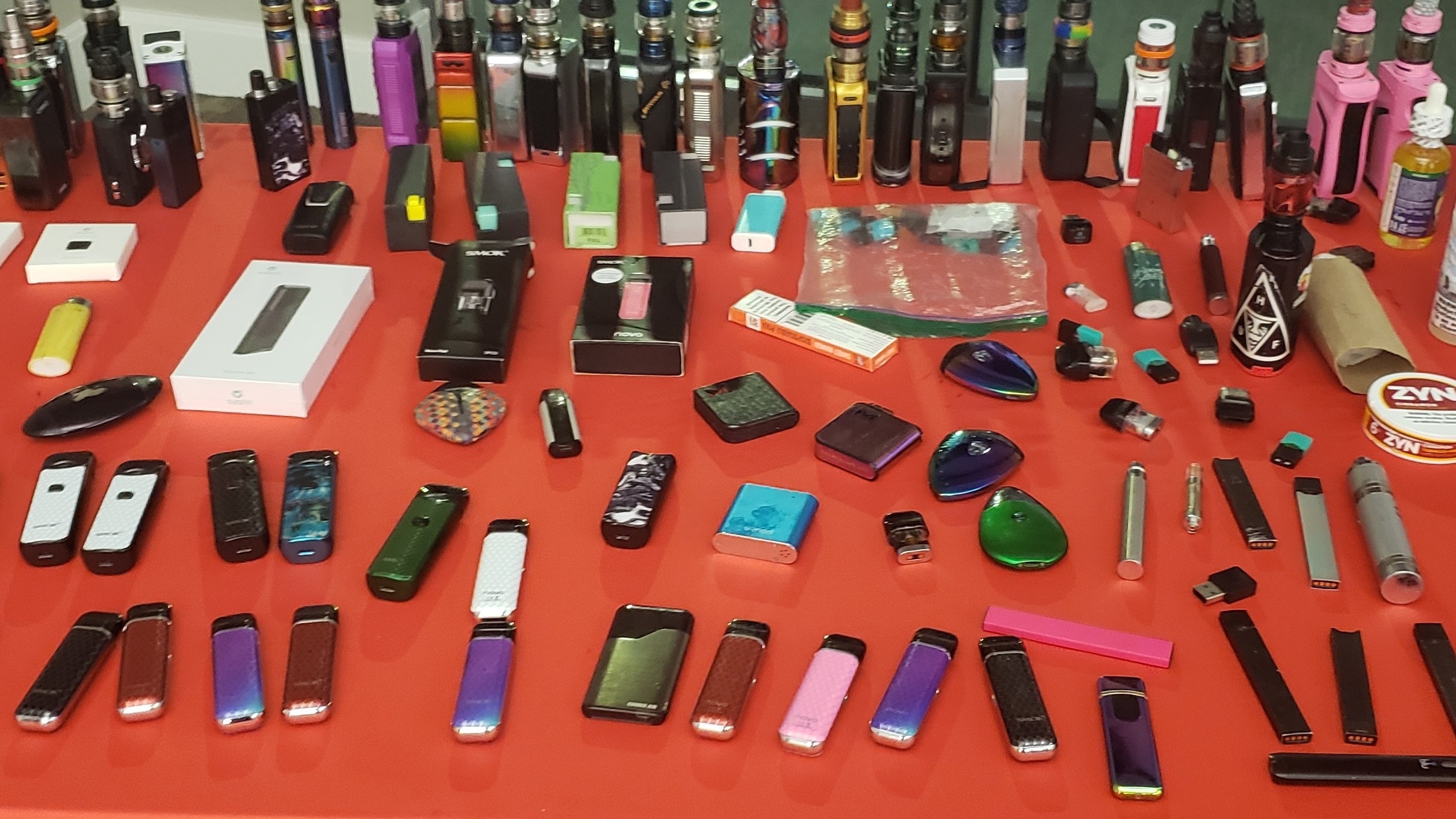 A table with a variety of vape devices confiscated from high school students
