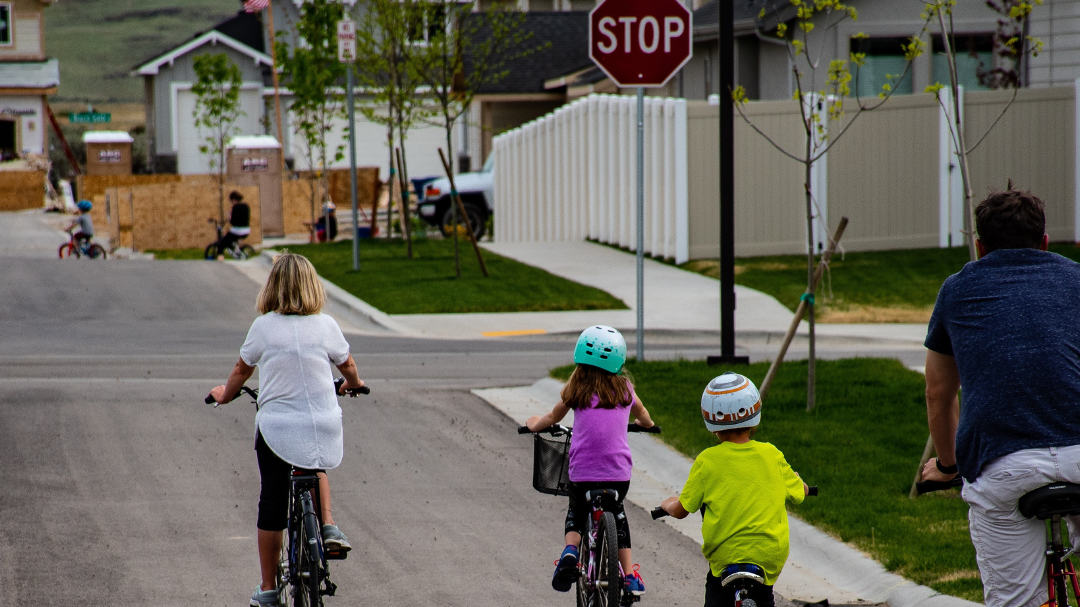 3 kids on bikes with an adult on a bike