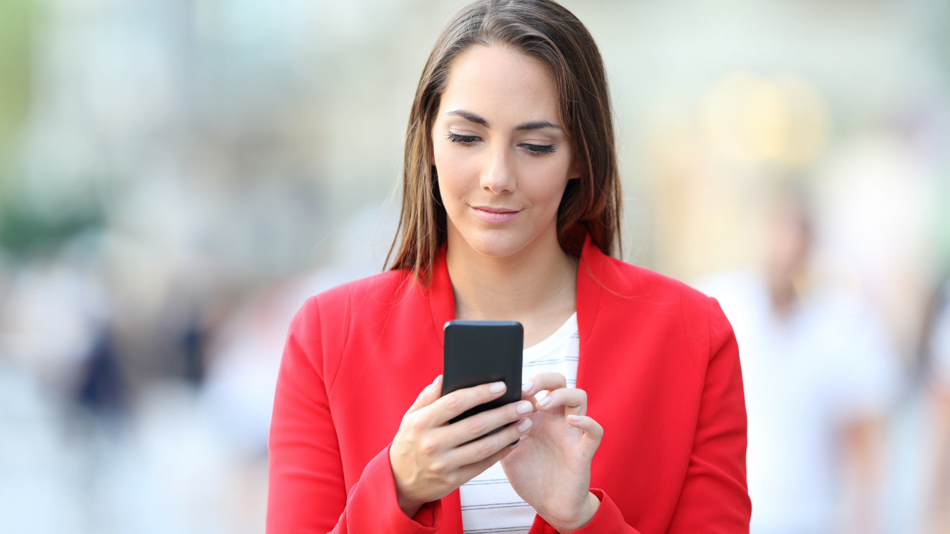 woman wearing red uses phone